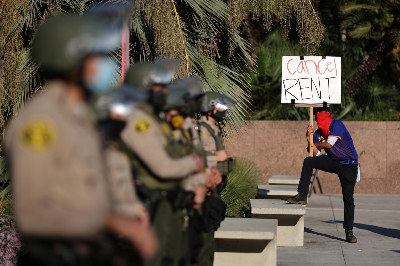 Tenants and housing rights activists protest for a halting of rent payments and mortgage debt as sheriff's deputies block the entrance to the courthouse in Los Angeles, California on October 1, 2020. 