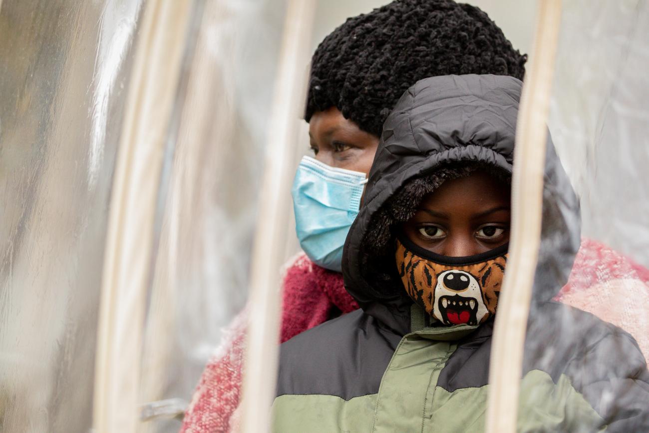 Families gather in "bubbles" during a training session as part of an outreach program to the Black community to increase vaccine trial participation in Rochester, New York on November 14, 2020. 