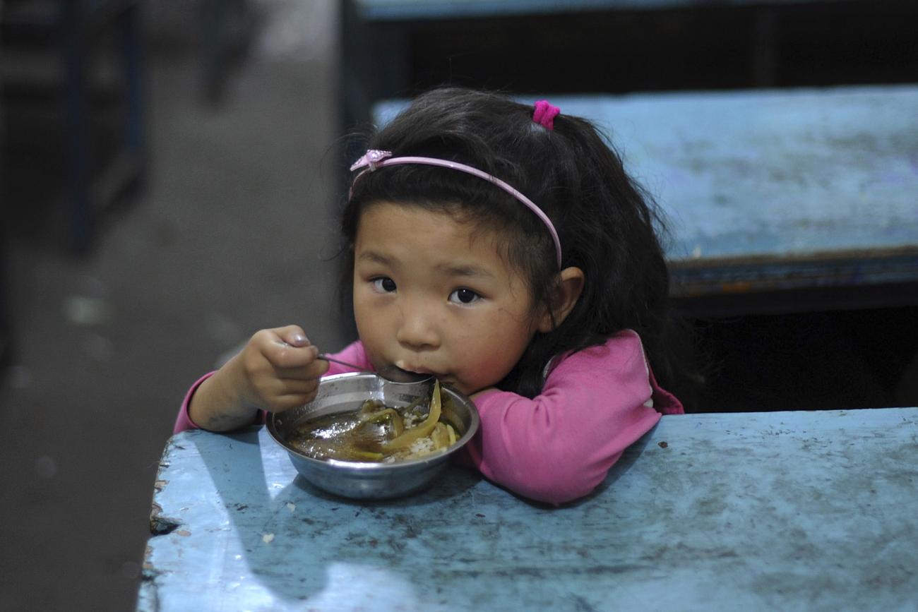 A child eats her lunch in a classroom at a primary school in Hefei, Anhui Province, China on June 1, 2011.