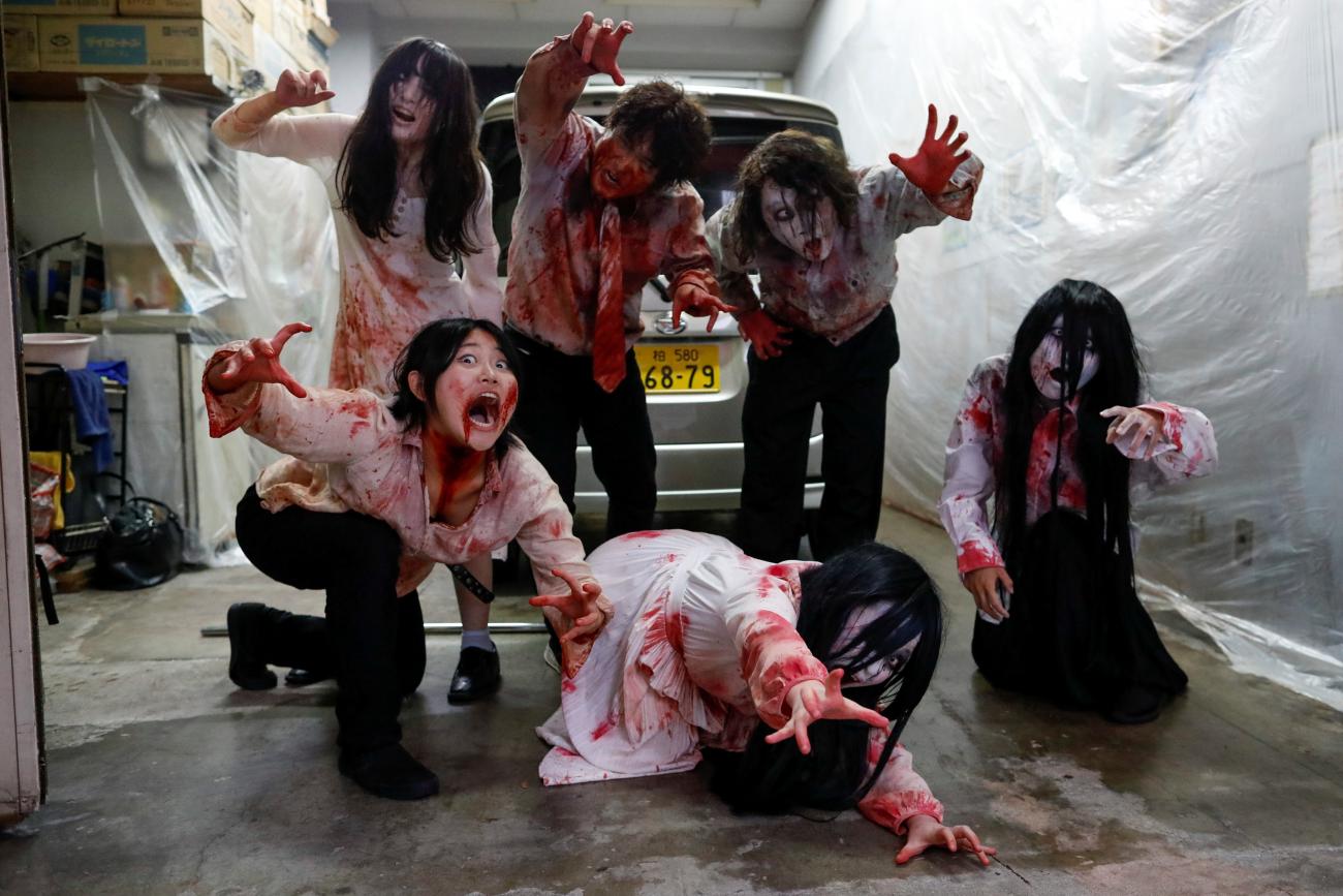Actors dressed as zombies or ghouls pose for a photograph before their performance at a drive-in haunted house show by Kowagarasetai (Scare Squad), for people inside a car in order to maintain social distancing amid the spread of the coronavirus disease (COVID-19), at a garage in Tokyo, Japan July 3, 2020.