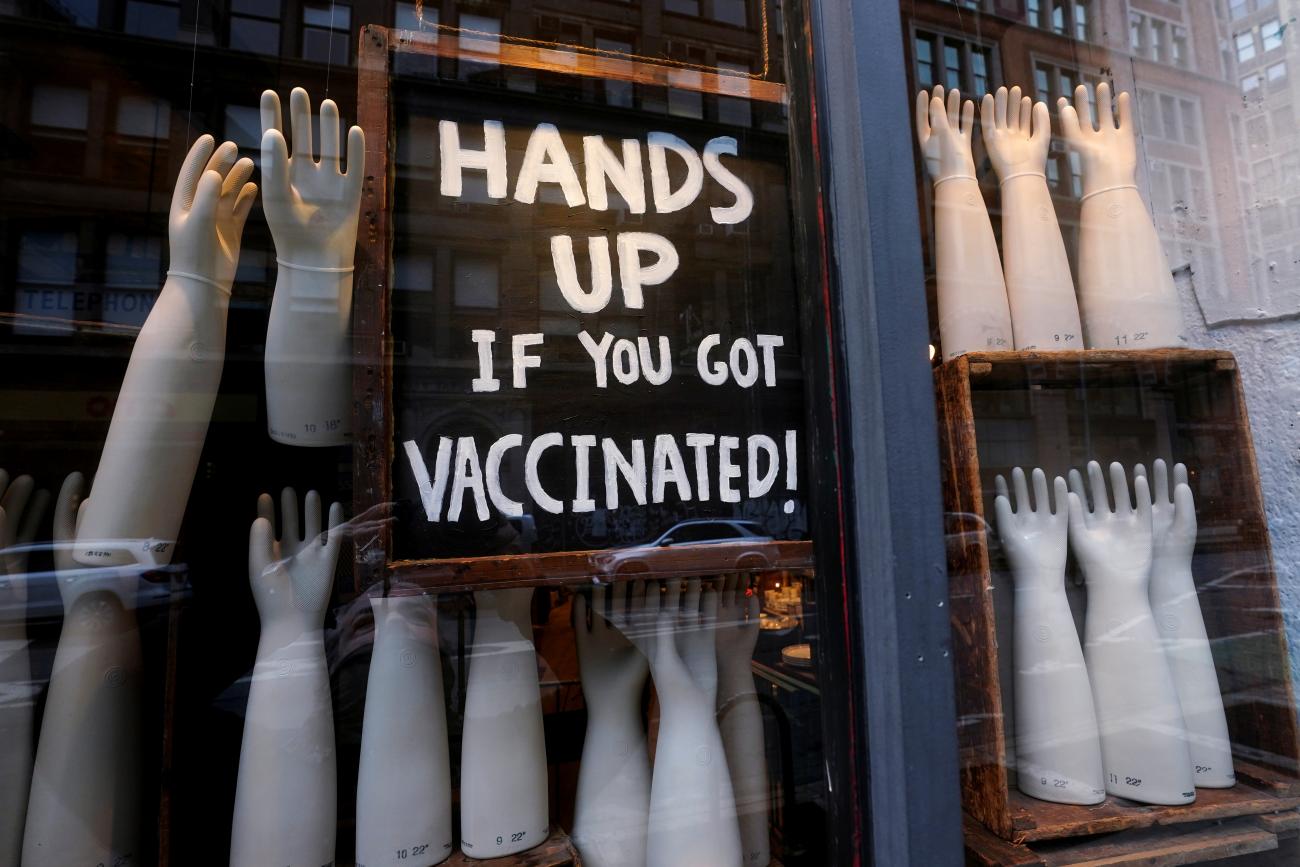 A sign in a store reads "Hands up if you got vaccinated" amid the coronavirus disease (COVID-19) pandemic in the Manhattan borough of New York City, New York, U.S., January 27, 2021.