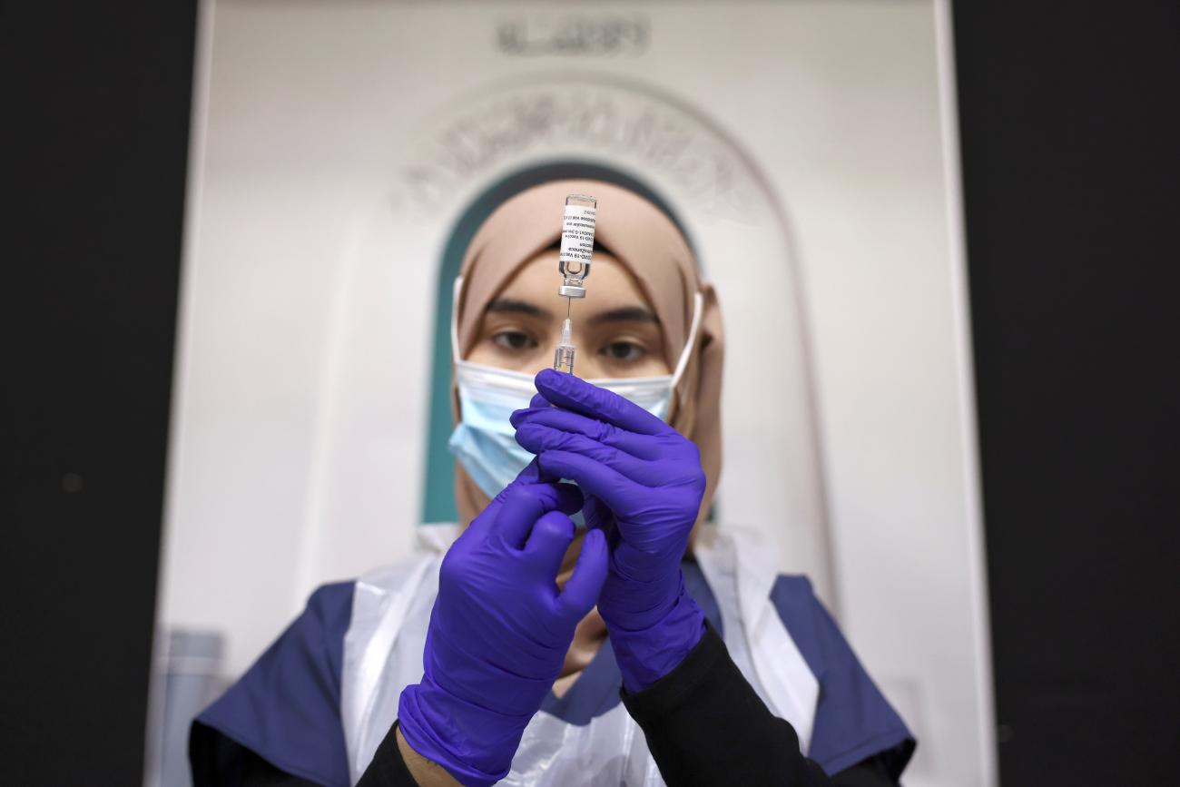 A medical worker prepares an injection with a dose of Astra Zeneca coronavirus vaccine, at a vaccination centre in Baitul Futuh Mosque, amid the outbreak of coronavirus disease (COVID-19), in London, Britain, March 28, 2021