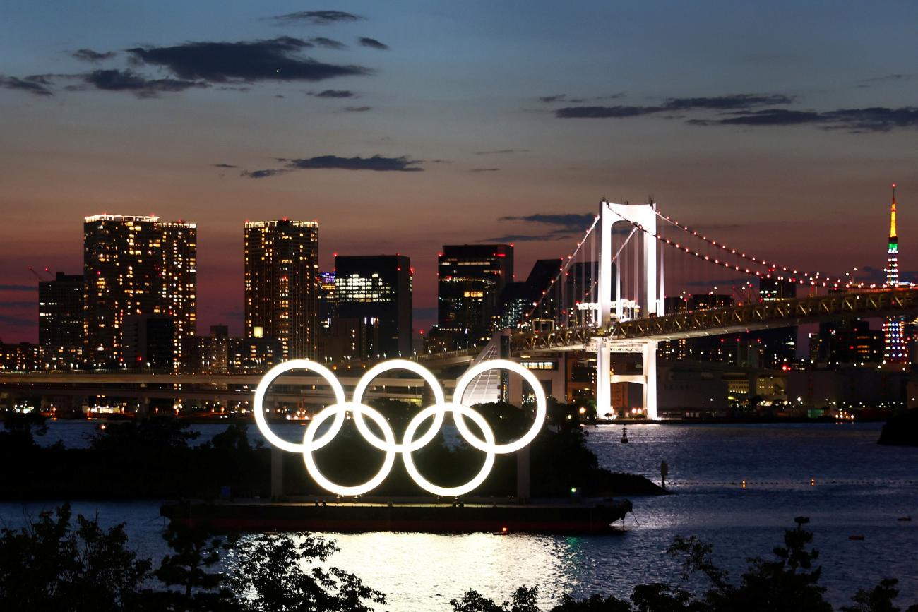 The Olympic Rings are seen in front of the skyline during sunset one night ahead of the official opening of the Tokyo 2020 Olympic Games in Tokyo, Japan, July 22, 2021.