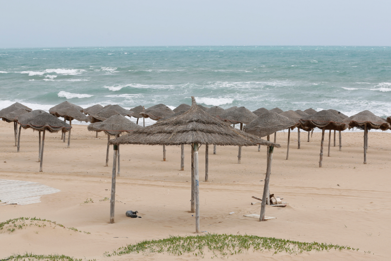A deserted beach with umbrellas made of natural materials is pictured during an extended lockdown aimed at stemming the spread of COVID-19 in April 2020 in Tunis, Tunisia.