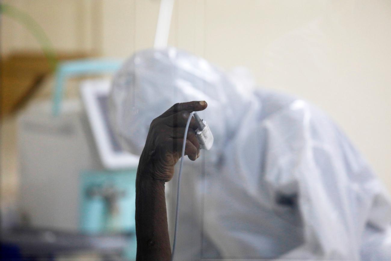 A coronavirus disease patient holds up his hand inside the COVID-19 ICU of Machakos Level 5 Hospital, in Machakos, Kenya October 28, 2020.
