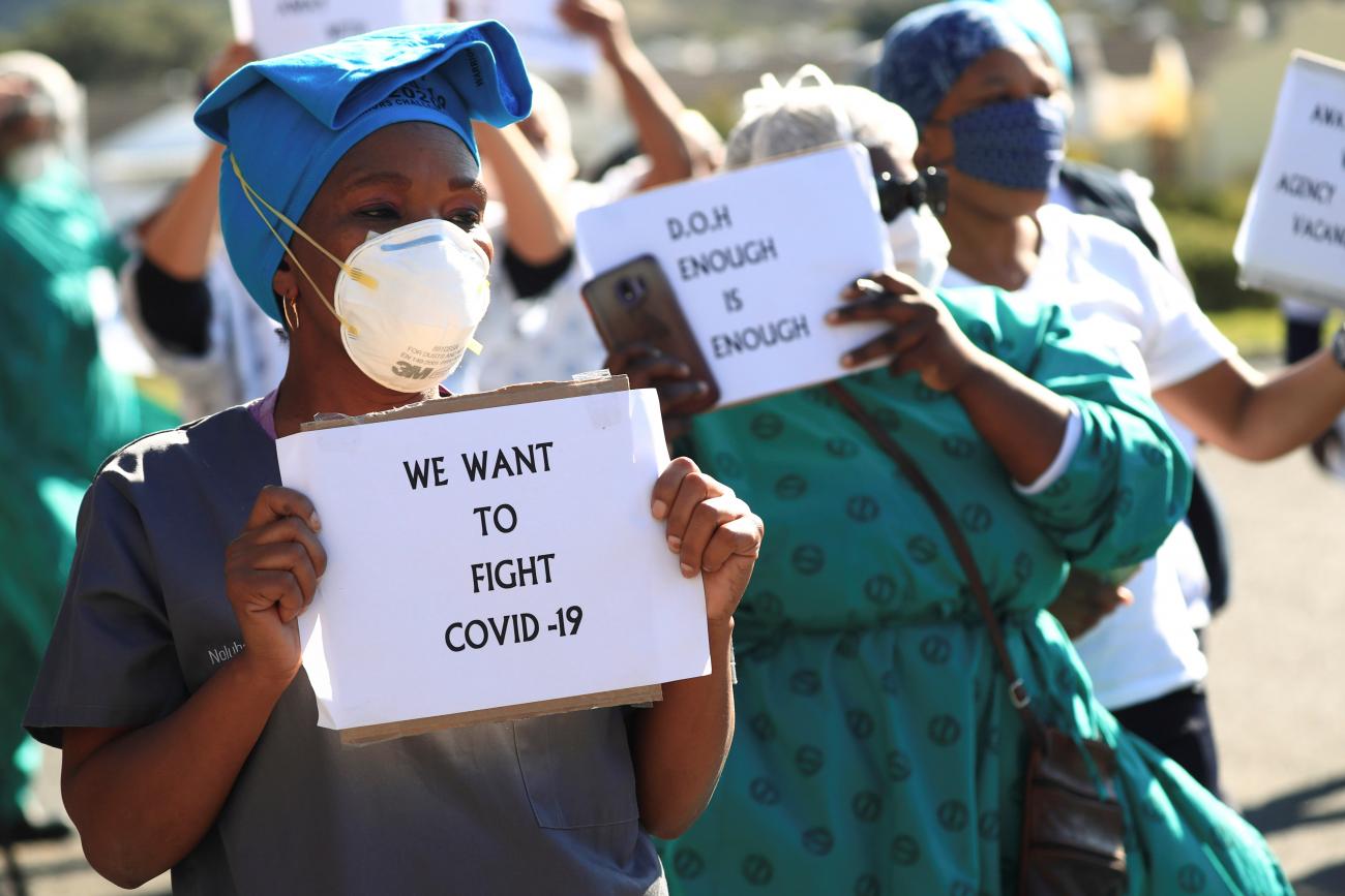 Health care workers holding signs, protest over the lack of personal protective equipment (PPE) during the coronavirus disease (COVID19) outbreak, outside a hospital in Cape Town, South Africa, June 19, 2020