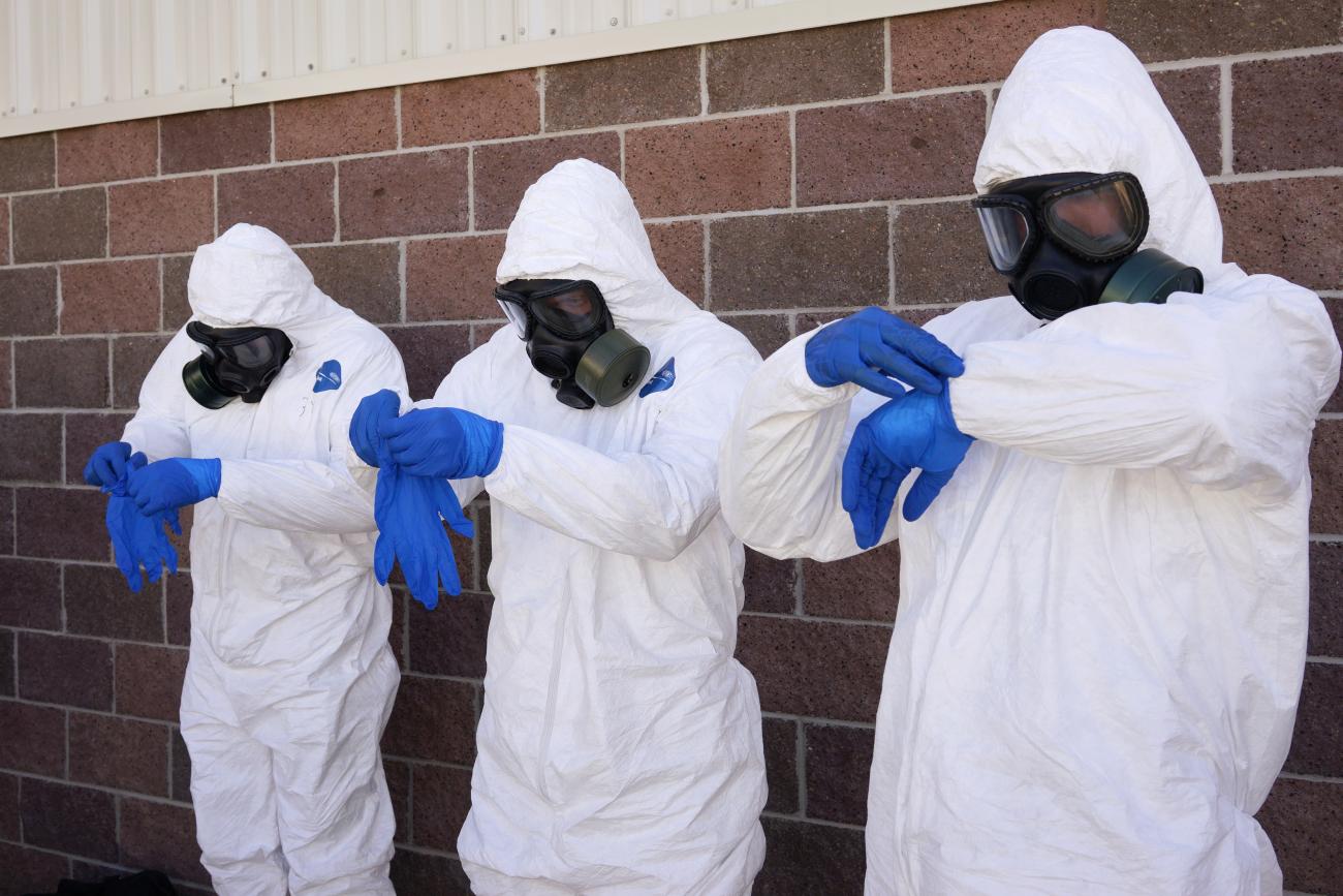 Soldiers from the U.S. Army 615th Engineer Company, 52nd Engineer Battalion put on one of three pairs of protective gloves during the final session of personal protective equipment training at Ft. Carson in Colorado Springs, Colorado October 23, 2014. The engineers were getting their final training prior to being deployed to Africa as part of the U.S. military's response to the Ebola crisis. 