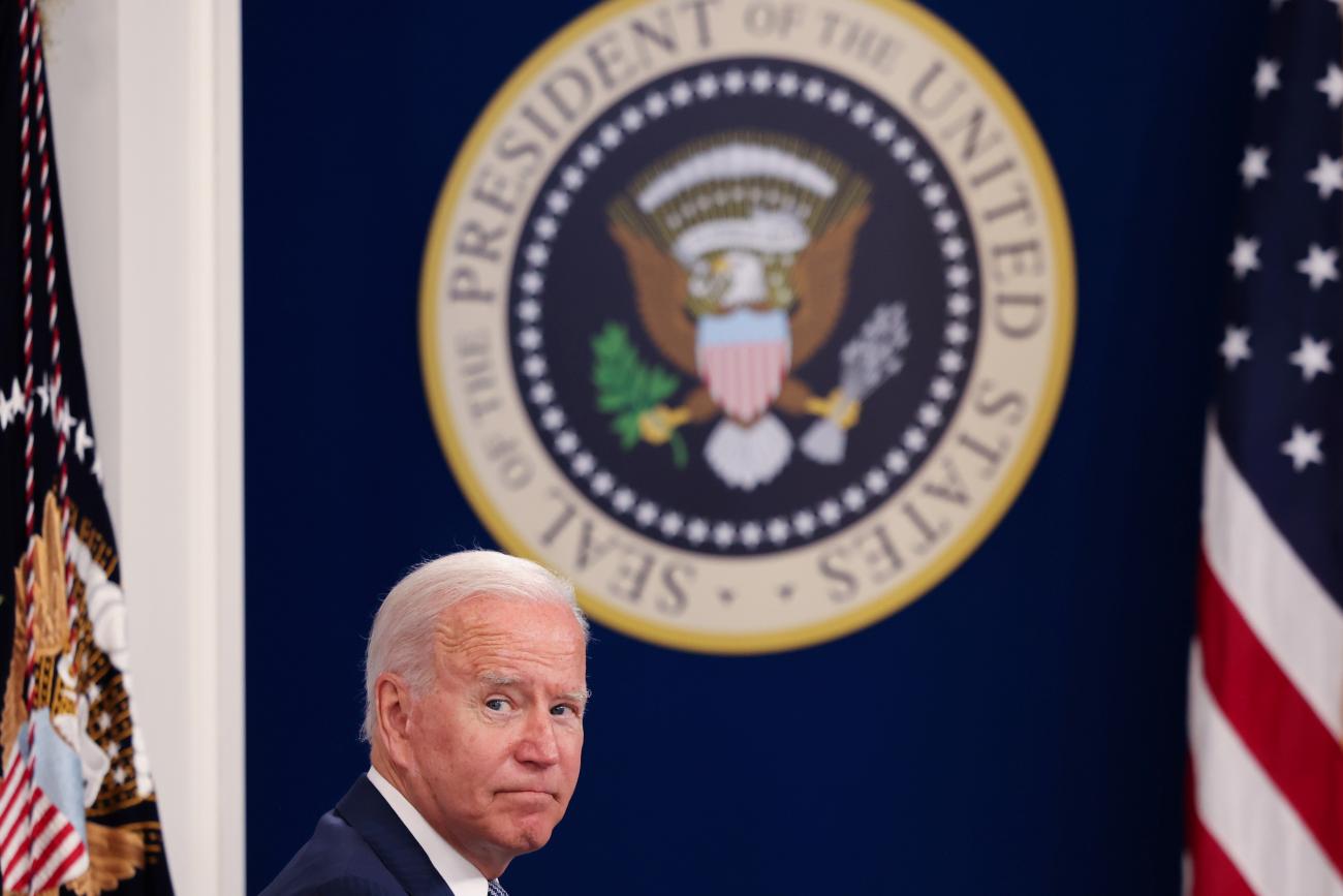 U.S. President Joe Biden sits in front of a large UShosts a virtual COVID Summit from the White House in Washington, DC, on September 22, 2021.
