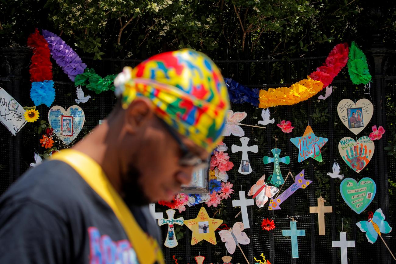 A man passes a "Naming the Lost Memorials” site—memorials curated by artists and activists in memory of those who’ve died of COVID-19, at The Green-Wood Cemetery in Brooklyn, New York, on June 10, 2021.