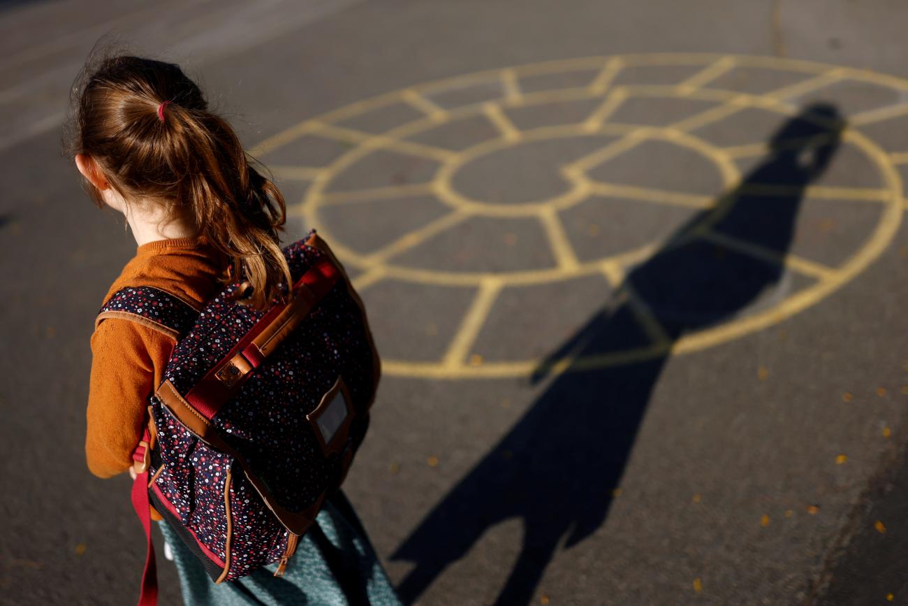 A child arrives at a primary school on the first day of the new school year after summer break in Vertou, France, on September 2, 2021. 