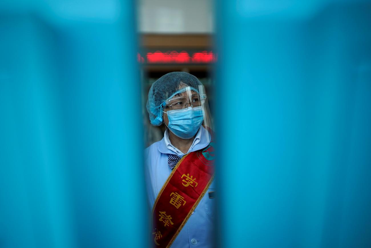  worker wears a mask and a face shield during a government organised media tour at Tongji Hospital following the coronavirus disease (COVID-19) outbreak, in Wuhan, Hubei province, China 