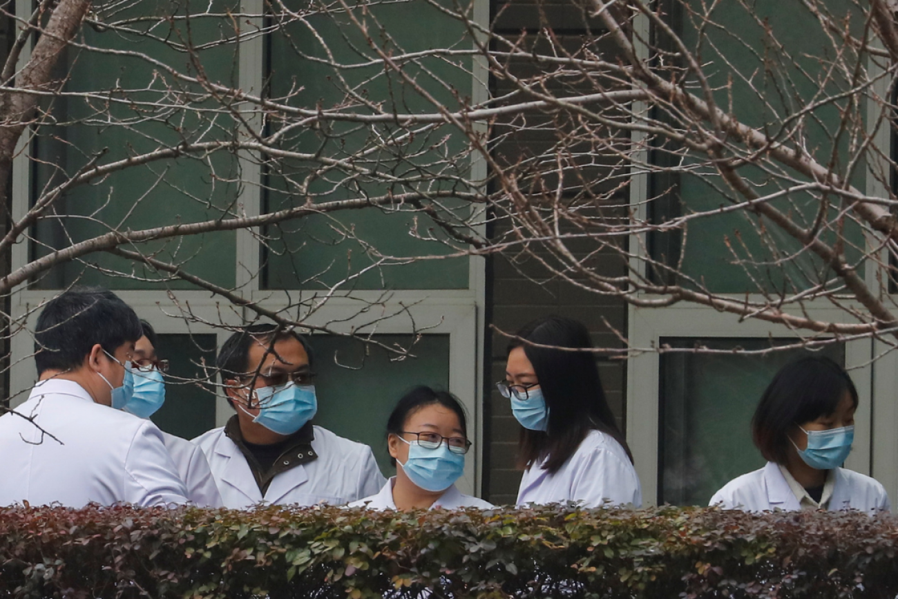 Chinese scientists and officials wait at the Hubei Animal Epidemic Disease Prevention and Control Center during a visit with a World Health Organization (WHO) team investigating the origins of COVID-19, in Wuhan, Hubei province, China, on February 2, 2021.