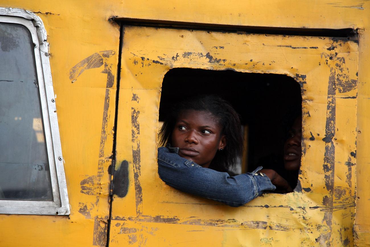 DOCUMENT DATE: March 27, 2009 Commuters peer from a broken window on a public bus in Lagos, March 27, 2009.