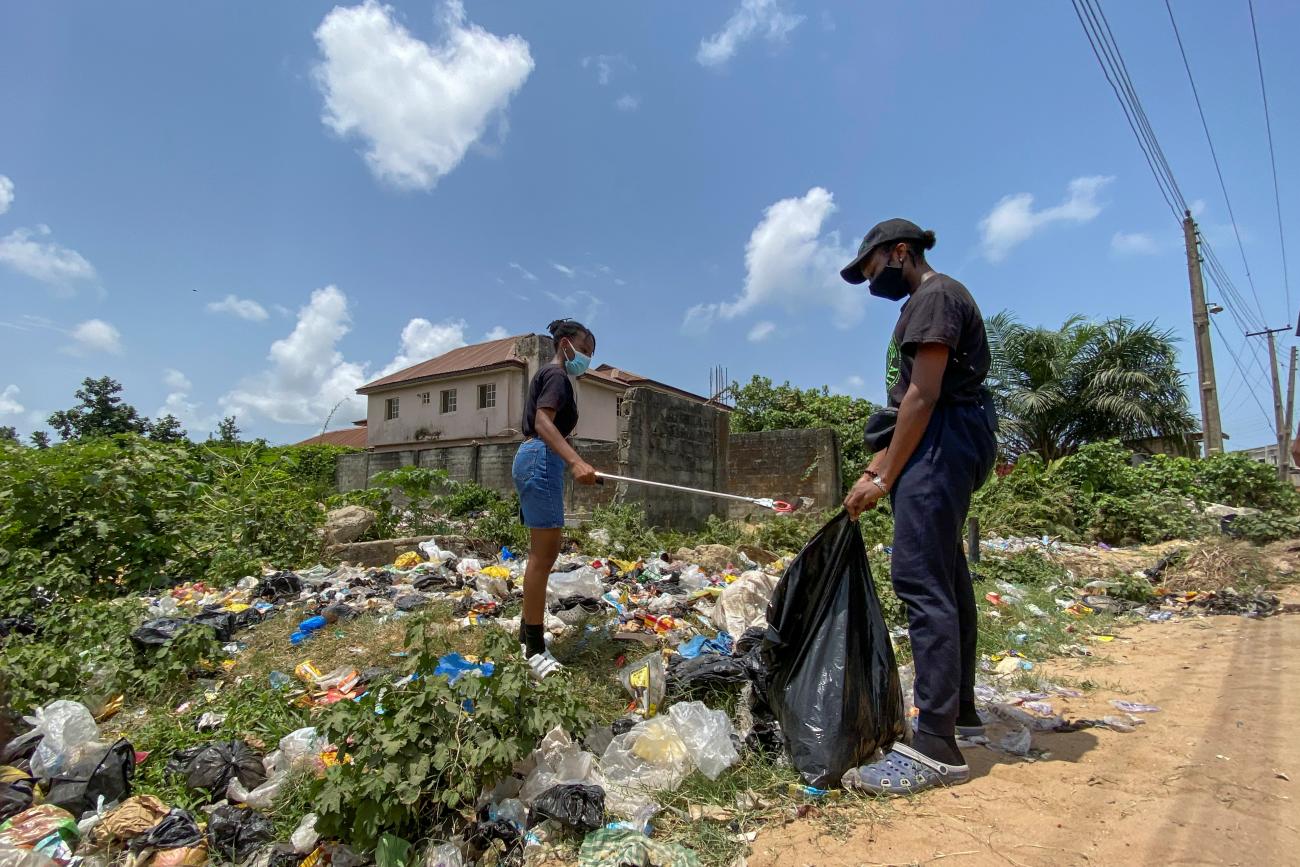 Esohe Ozigbo, a 15-year-old climate change activist, is seen during one of her campaign picking up refuse disposed carelessly in Lagos, Nigeria April 16, 2021. Picture taken April 16, 2021