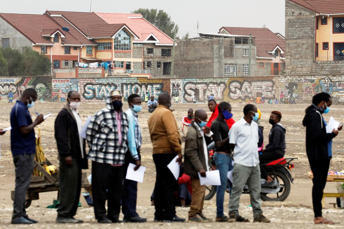 People wait in line to receive the AstraZeneca/Oxford COVID-19 vaccine, donated to Kenya by the UK government, in Nairobi, Kenya, August 8, 2021.