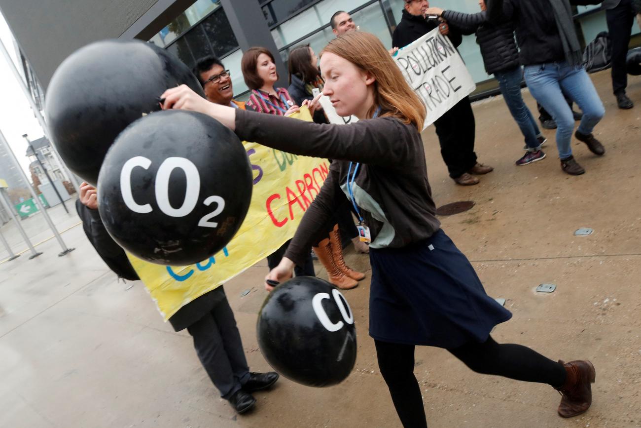 Activists protest against the carbon dioxide emissions trading in front of the World Congress Centre Bonn, the site of the COP23 U.N. Climate Change Conference, in Bonn