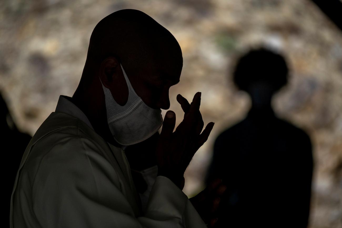 A church-goer crosses himself during Sunday mass at a structure next to the under renovation Saint Therese Catholic Church after unrest triggered by COVID-19 curbs, which have already rocked the nearby island of Guadeloupe, in Fort-de-France, Martinique November 28, 2021