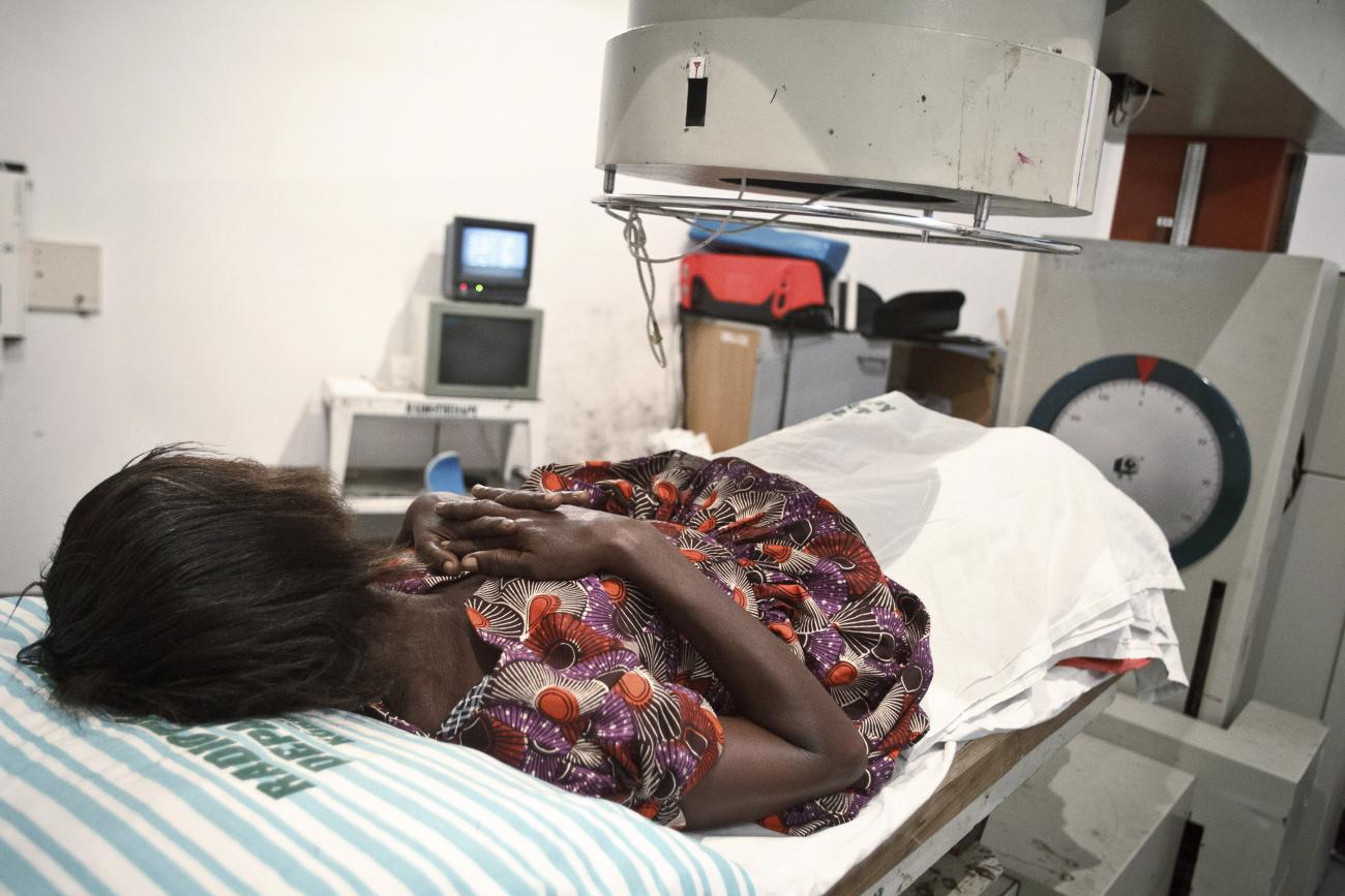 A 52-year-old woman suffering from bladder cancer lies under a radiotherapy simulator used to pinpoint areas to treat at the Korle Bu Teaching Hospital in Accra April 24, 2012.