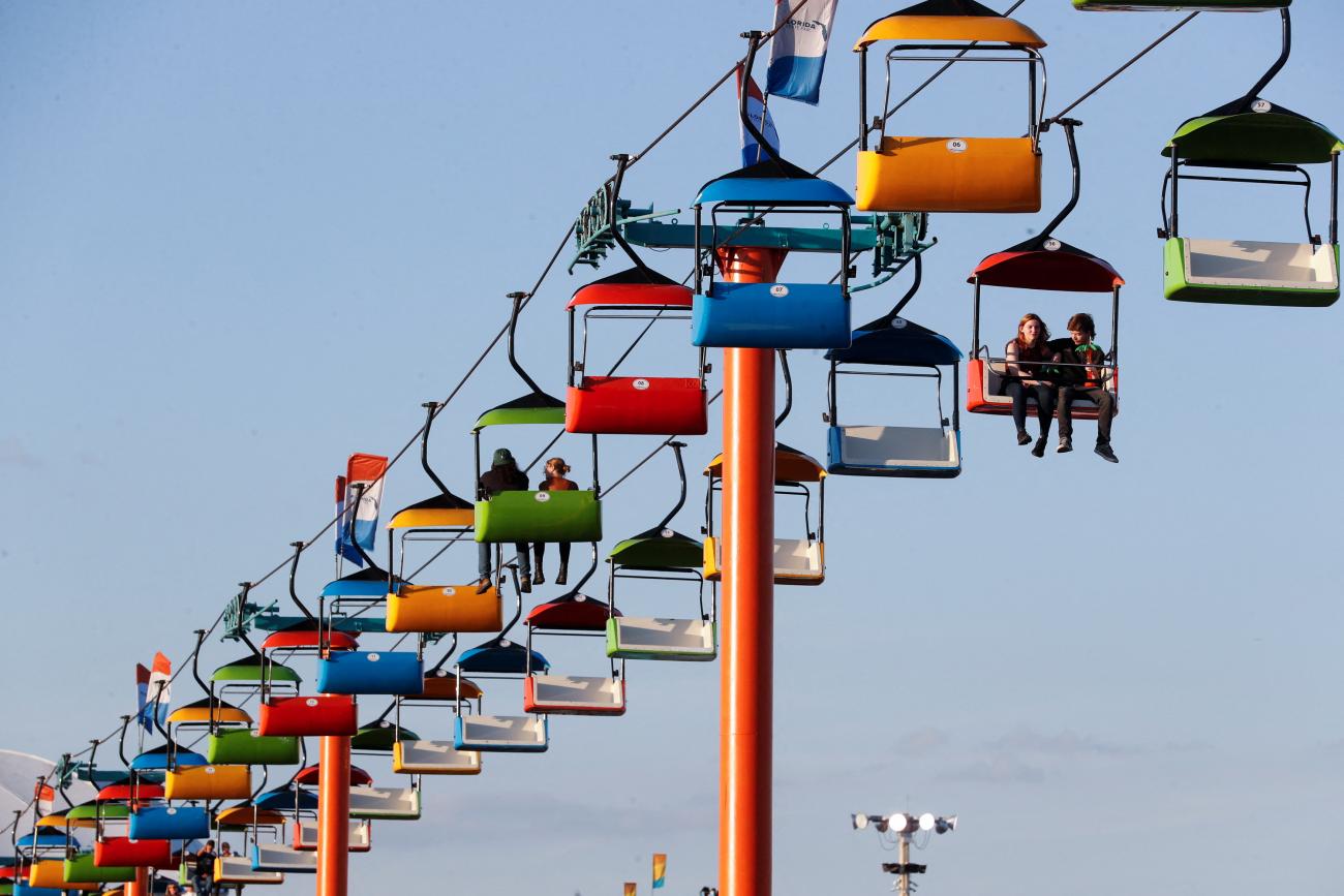 People with and without masks attend the Florida State Fair as the new omicron “stealth variant” BA.2 spreads, in Tampa, Florida, February 11, 2022. 