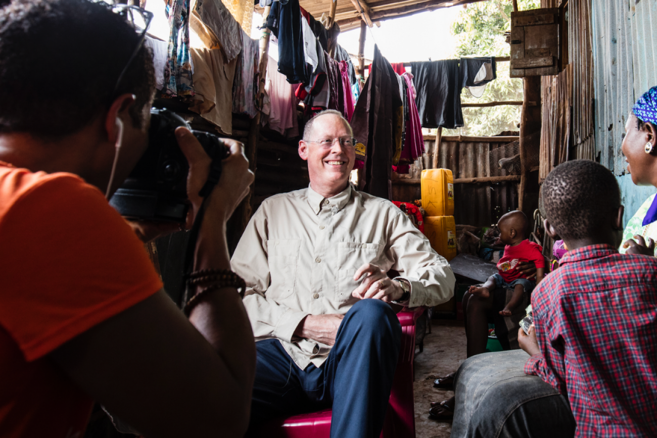 Paul Farmer visits Ebola survivor Yabom Koroma and her family at their home in the Mountain Court section of Freetown, Sierra Leone on December 14, 2015. Photo courtesy of PIH.