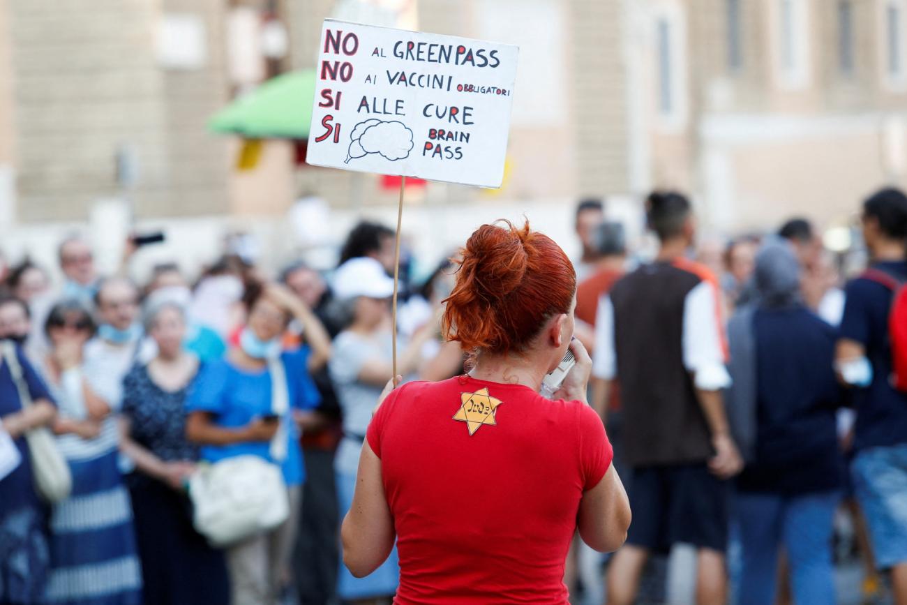 a protestor in a red shirt appropriates the Star of David 