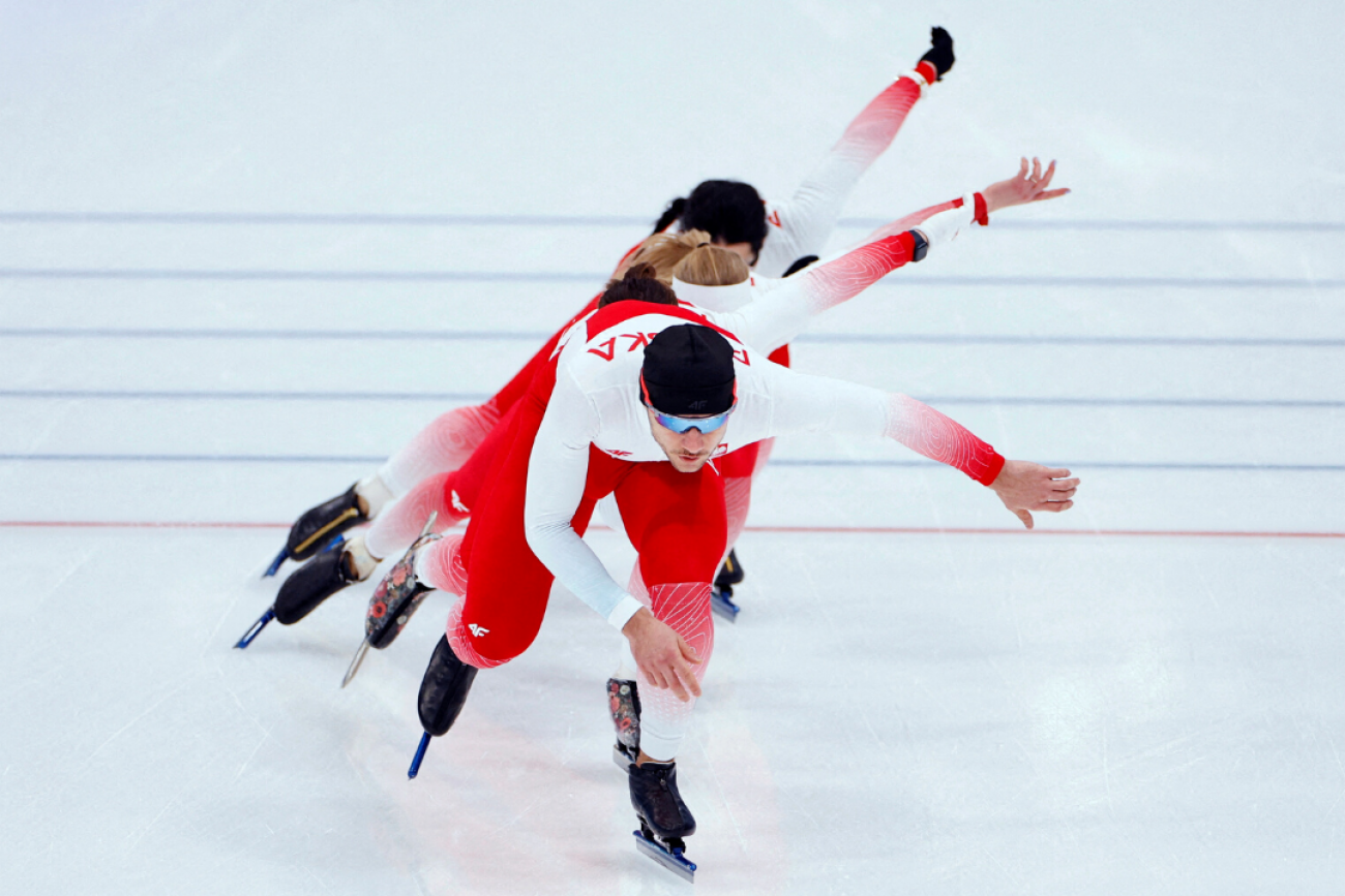 Athletes from Poland warm up for the Men's 5000m speed skating competition at the 2022 Winter Olympics, in the National Speed Skating Oval, in Beijing, China, on February 6, 2022. 
