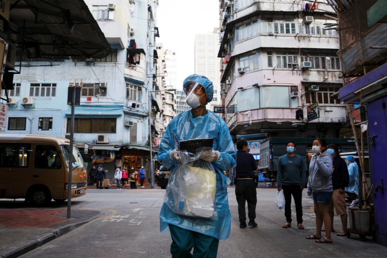 A medical worker in a protective suit walks near the residential area at Jordan, after the expand of mandatory coronavirus disease (COVID-19) testing, in Hong Kong, China January 19, 2021