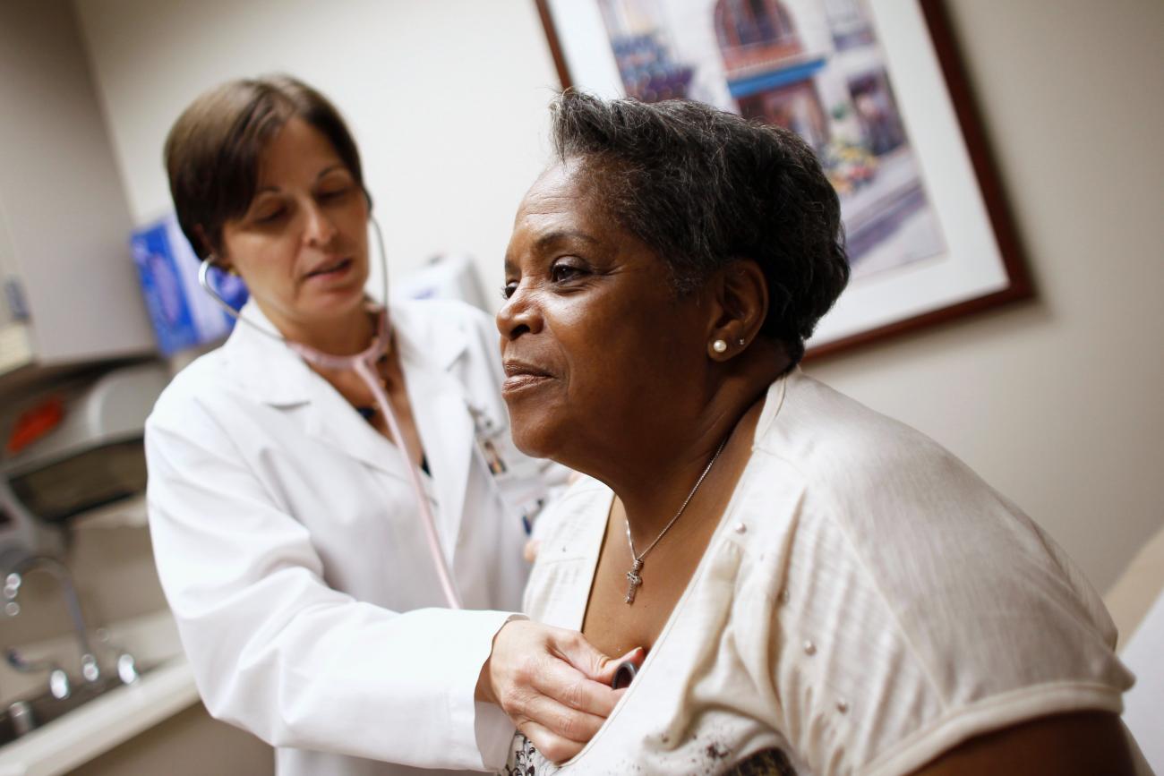 A woman receives a checkup from her primary care physician in Chicago, Illinois, June 28, 2012.