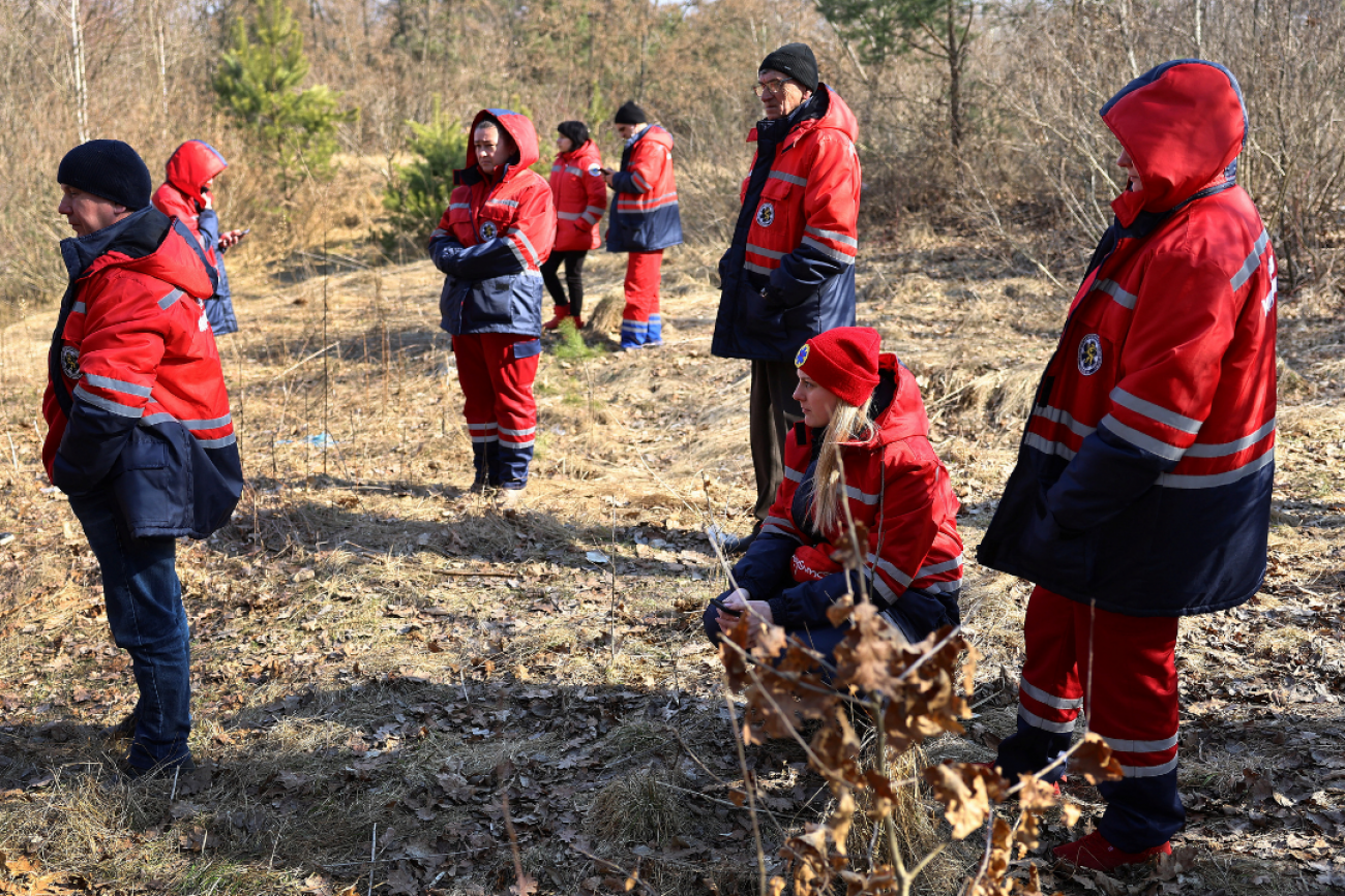 Ukrainian paramedics take cover in the woods as air raid sirens go off again following an attack on the Yavoriv military base, outside a hospital in Yavoriv, Ukraine, during Russia’s invasion of Ukraine, on March 13, 2022. 