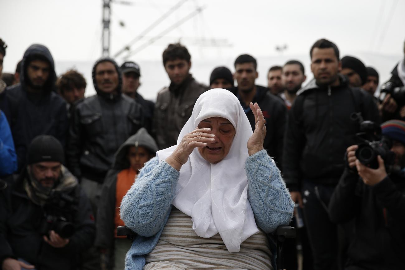 A displaced woman in a wheelchair cries during a protest at a makeshift camp at the Greek-Macedonian border near the village of Idomeni, Greece, on March 27, 2016.