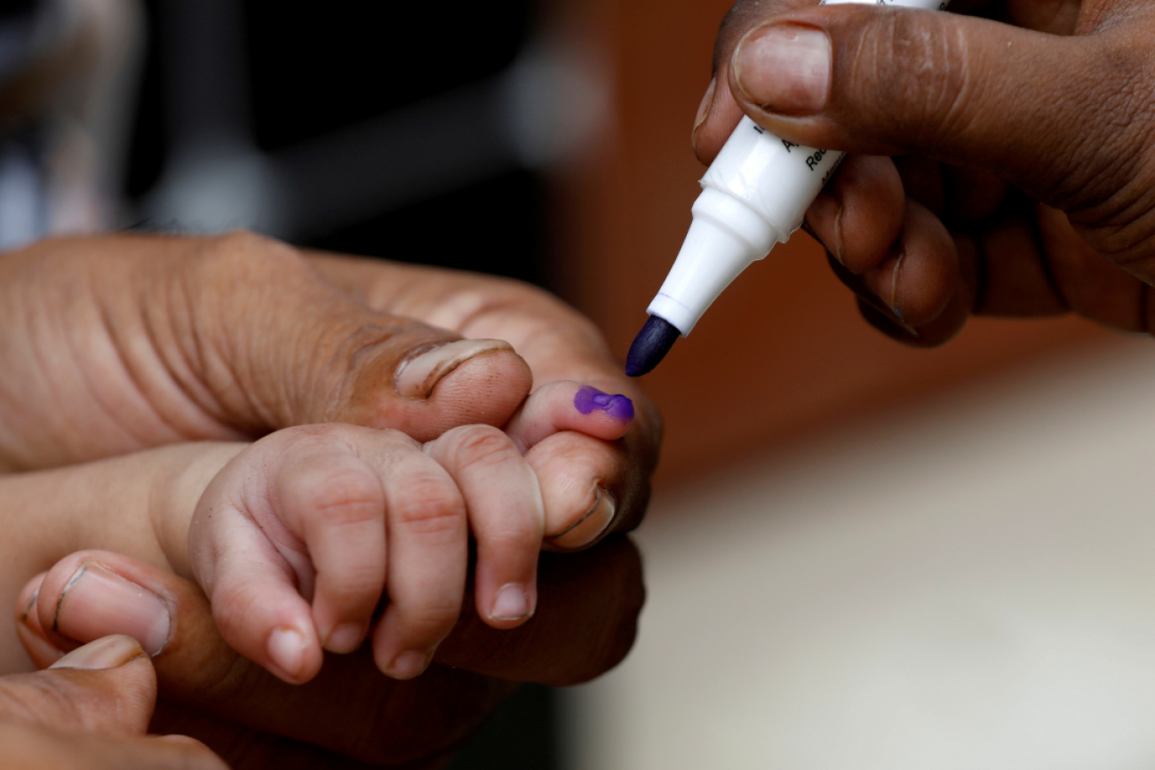 A close-up image of a child's hand being marked with a purple pen after he is administered polio vaccine drops, during an anti-polio campaign in Karachi, Pakistan, on July 20, 2020. 