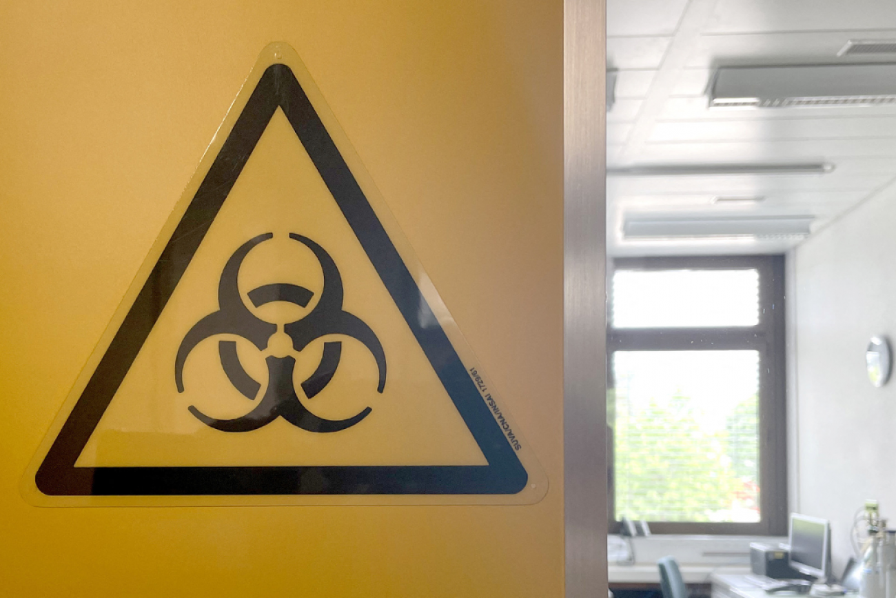 A large yellow biohazard sign on the wall at the bio-containment facility at Spiez Laboratory, available to WHO as a repository for COVID viruses and other pathogens with pandemic potential, in Spiez, Switzerland, June 8, 2022. 