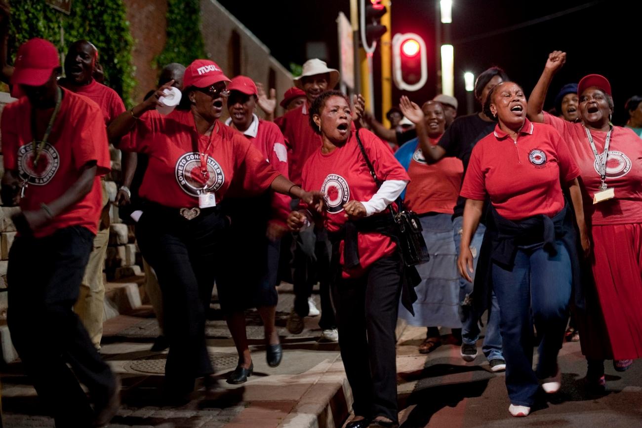 Activists and supporters of the Right 2 Know campaign chant slogans as they hold a night vigil outside the Constitutional Court in Johannesburg September 19, 2011.