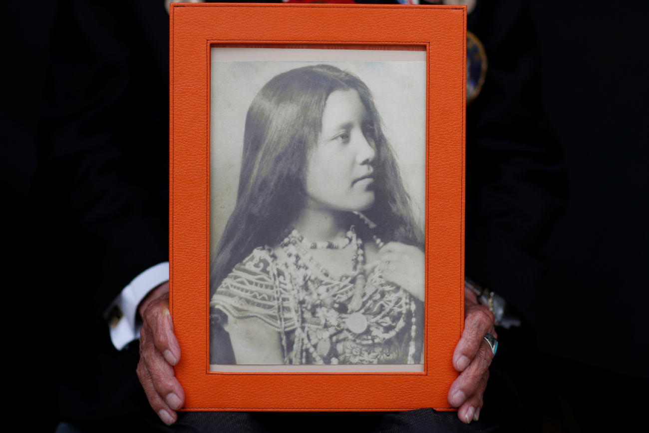 A close-up of the hands of Charles Norman Shay, a member of the Penobscot Nation and a World War II veteran, holding a picture of his mother Florence. Photo taken in Bretteville l'Orgueilleuse, France, on May 18, 2019. 