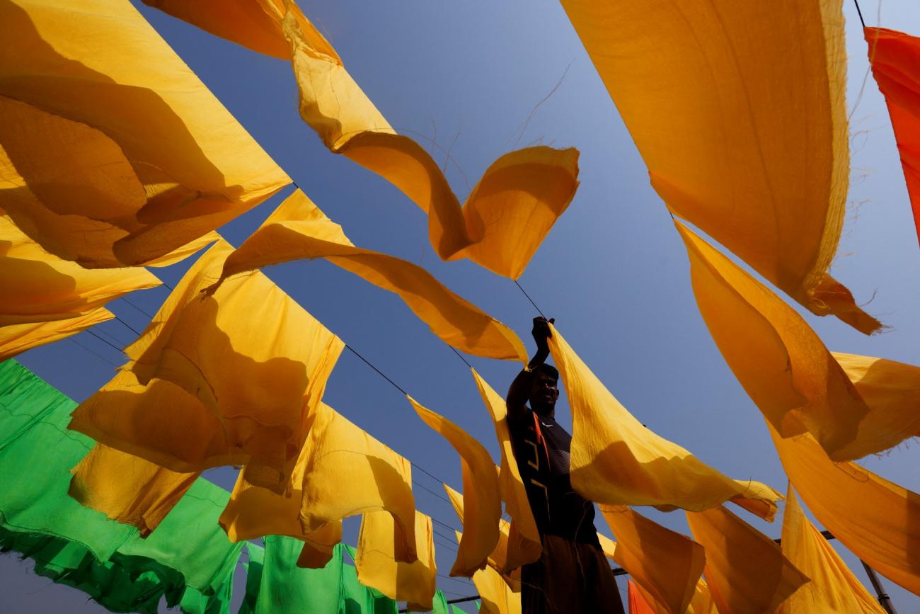 A worker dries fabrics at a dye factory in Narayanganj, Bangladesh, on March 9, 2022.