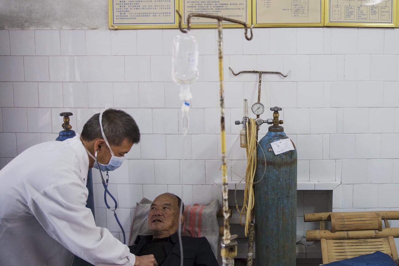 A doctor checks a patient in the hospital in Wuyi County, Zhejiang Province, China, on October 19, 2015. REUTERS/Damir Sagolj