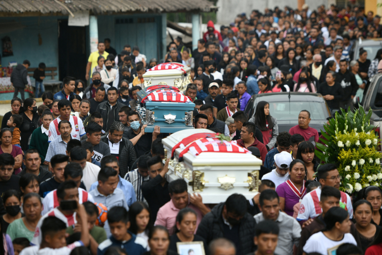 Relatives and friends carry the caskets of Jair Valencia, 19, Yovani Valencia, 16, and Misael Olivares, 16, at their funeral in San Marcos Atexquilapan, in Veracruz, Mexico, on July 15, 2022. They died in a human trafficker’s truck, in Texas, in June 2022.