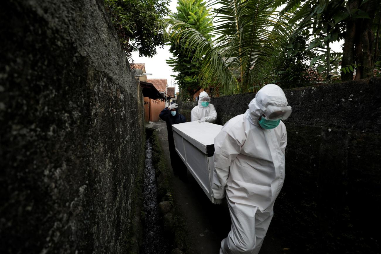 Volunteer undertakers help carry the coffin of 64-year-old Yoyoh Sa'diah who passed away due to complications related to COVID-19, at home in Bogor, West Java province, Indonesia, on July 8, 2021.