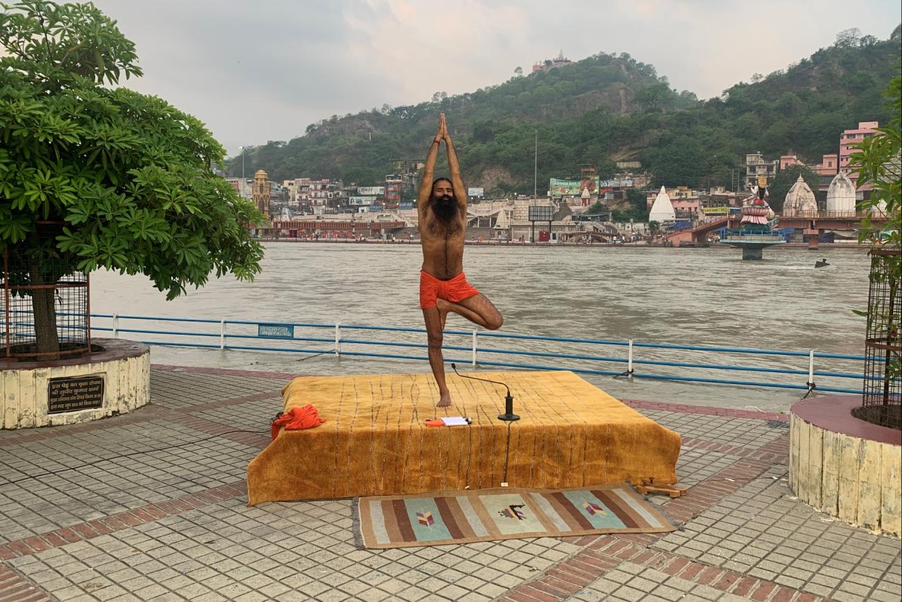 India's yoga guru Baba Ramdev practices yoga on the banks of the river Ganges ahead of International Yoga day, in the northern town of Haridwar, India, on June 19, 2020. 