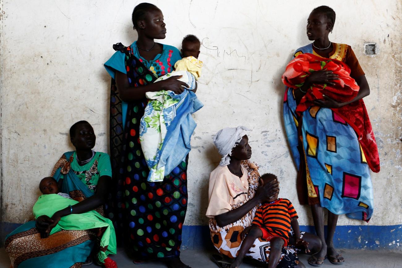 Women hold their babies as they wait for a medical check-up at a UNICEF-supported mobile health clinic in Nimini village, Unity State, South Sudan, on February 8, 2017.