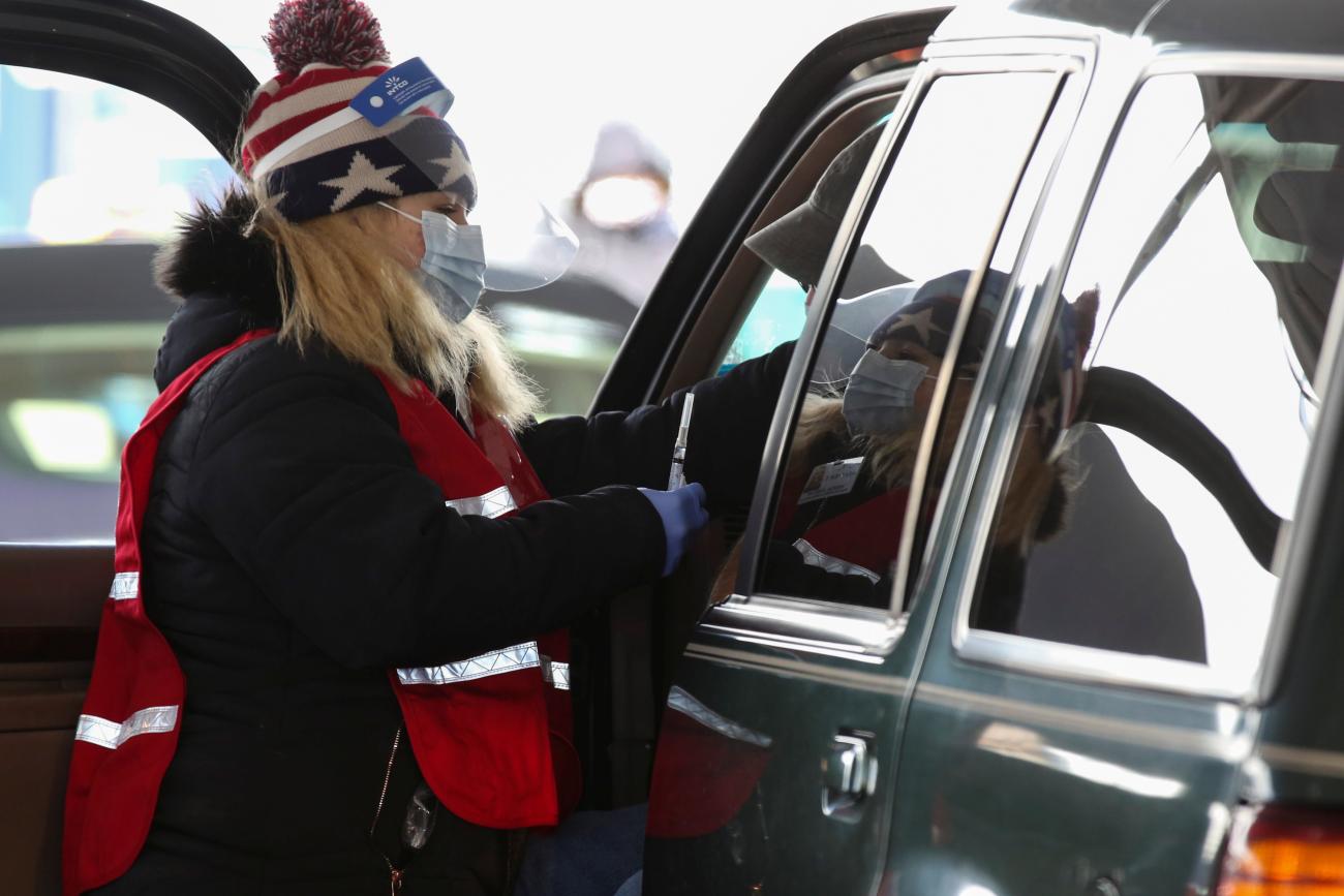 A health-care worker administers the Johnson & Johnson's coronavirus disease (COVID-19) vaccine to a person at New Hampshire Motor Speedway in Loudon, New Hampshire, on March 6, 2021.