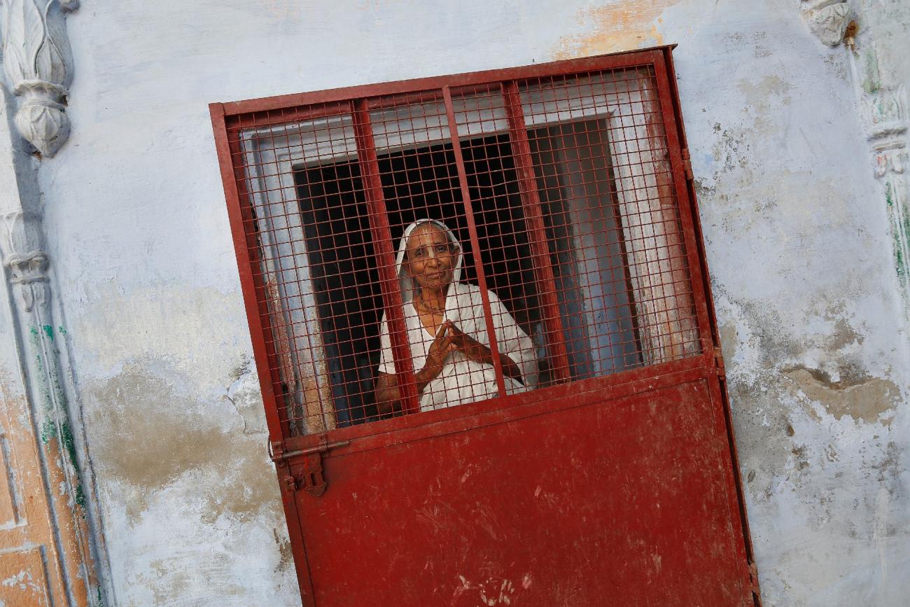 A widow poses at the entrance of a staircase at the Meera Sahavagini ashram in the pilgrimage town of Vrindavan, in Uttar Pradesh, India, on March 6, 2013.