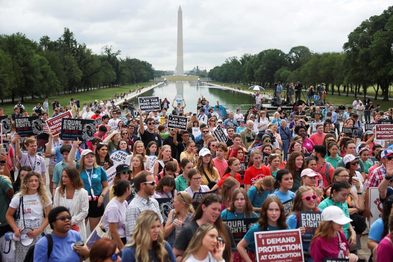 A crowd of anti-abortion demonstrators listen as former U.S. Vice President Mike Pence (not pictured) speaks at the "National Celebrate Life Day Rally" in Washington, DC.