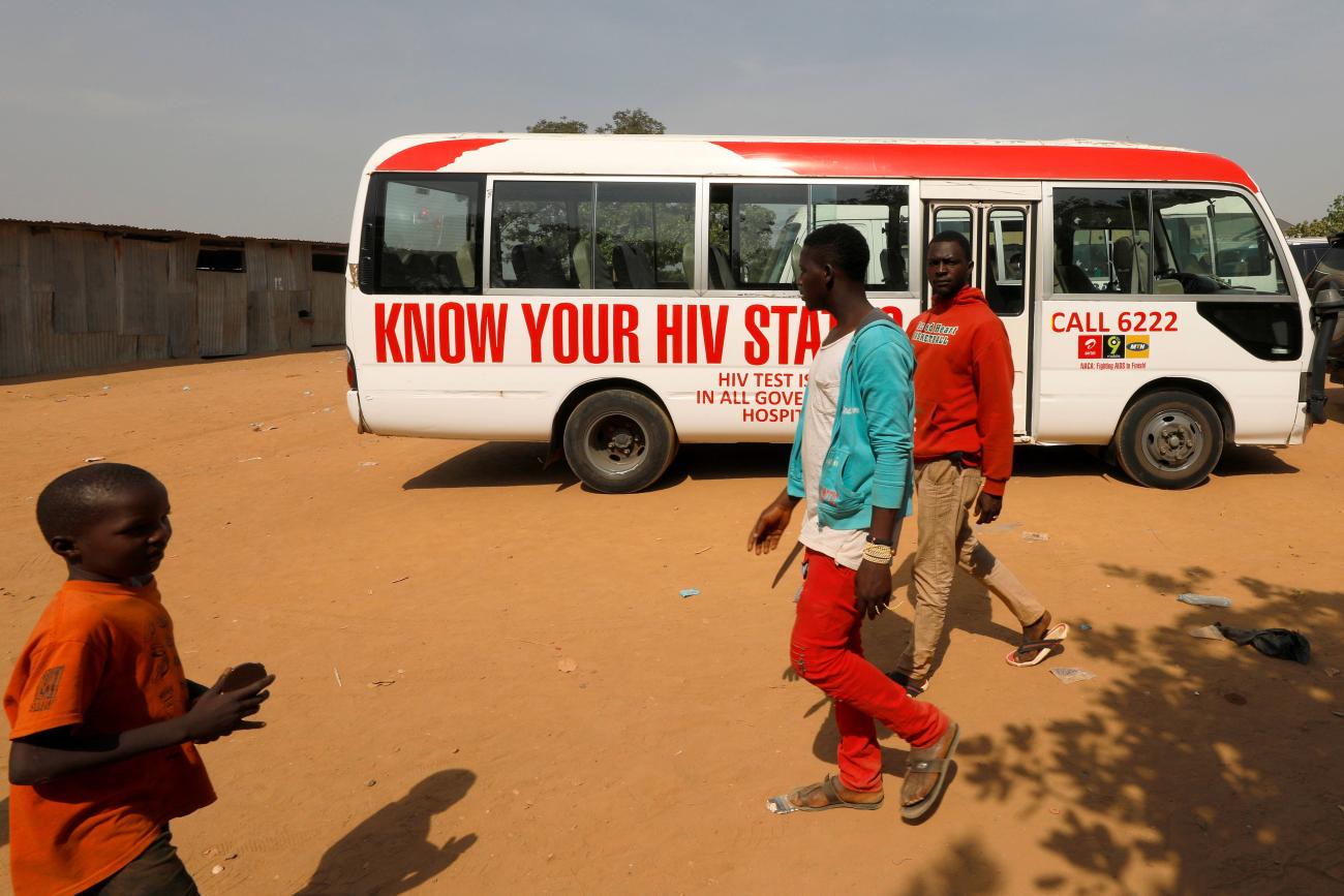 People walk past a bus during an HIV/AIDS awareness campaign on the occasion of World AIDS Day in Abuja, Nigeria, December 1, 2018.