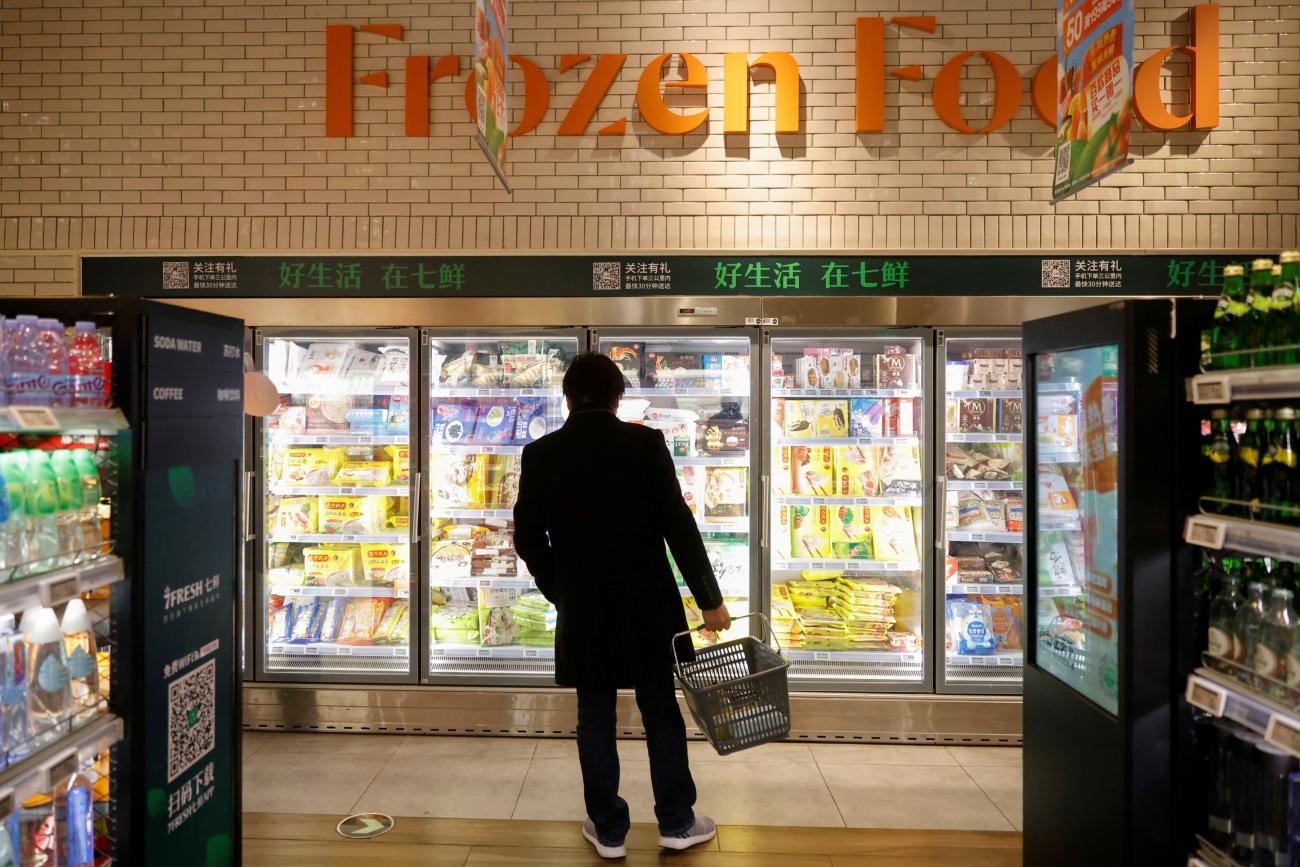 A customer looks at products in the frozen food section at JD's 7Fresh supermarket on China's Singles Day shopping festival during a government organized tour in Beijing, China November 11, 2020. 