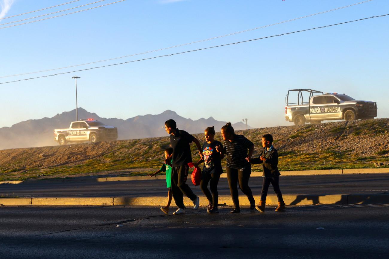 Migrants from Venezuela try to evade an operation carried out by police and agents of the National Institute of Migration (INM) of Mexico on the banks of the Rio Bravo River, the border between the U.S. and Mexico, in Ciudad Juarez, Mexico, October 6, 2023.