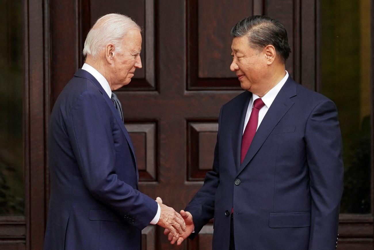 President Joe Biden shakes hands with President Xi Jinping