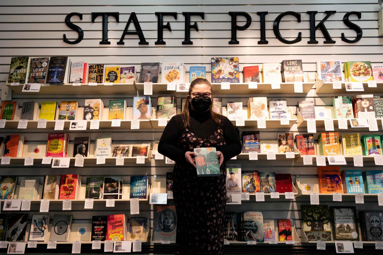 Honor Ford, a supervisor at the Doylestown Bookshop, holds a copy of "Heartstopper" that she donated as part of the "Read with Love Book Drive" run by PFLAG Bucks County to help place LGBTQ+ books in Bucks and Montgomery County libraries at the Doylestown Bookshop in Doylestown, Pennsylvania, U.S., April 7, 2023.