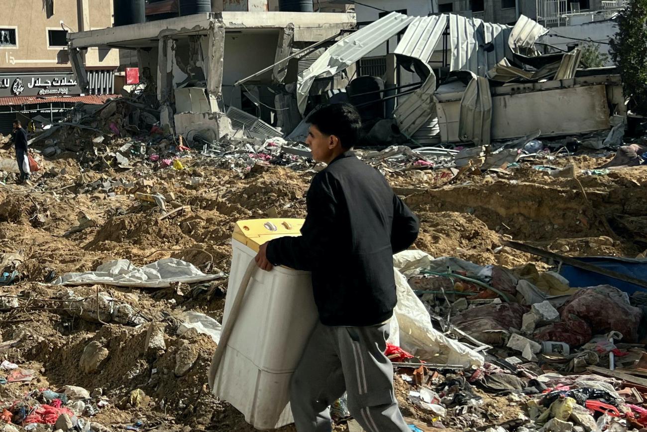 Palestinians inspect damages following an Israeli raid at Kamal Adwan hospital.