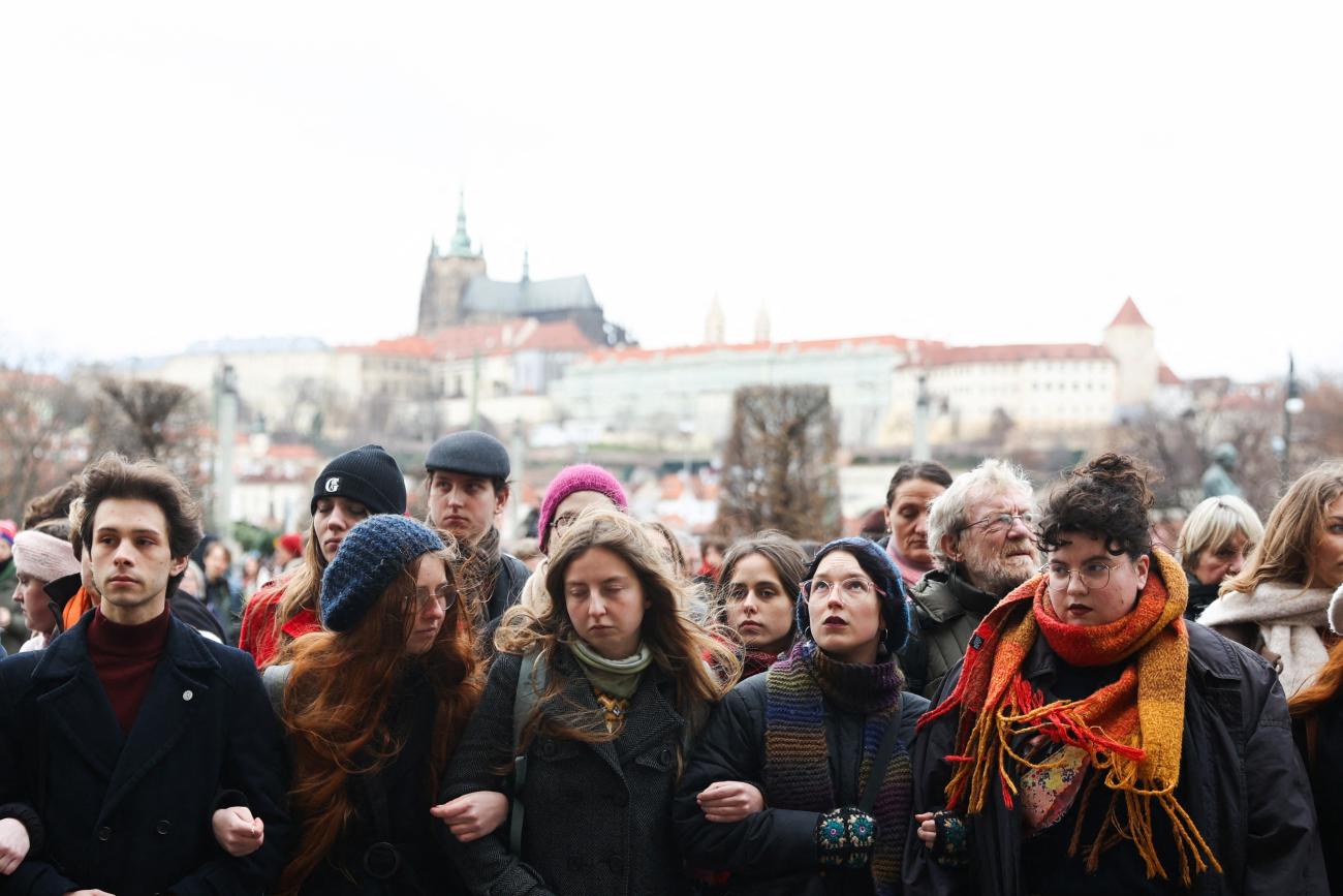 Students create a human chain in memory of victims of the shooting at Prague University.